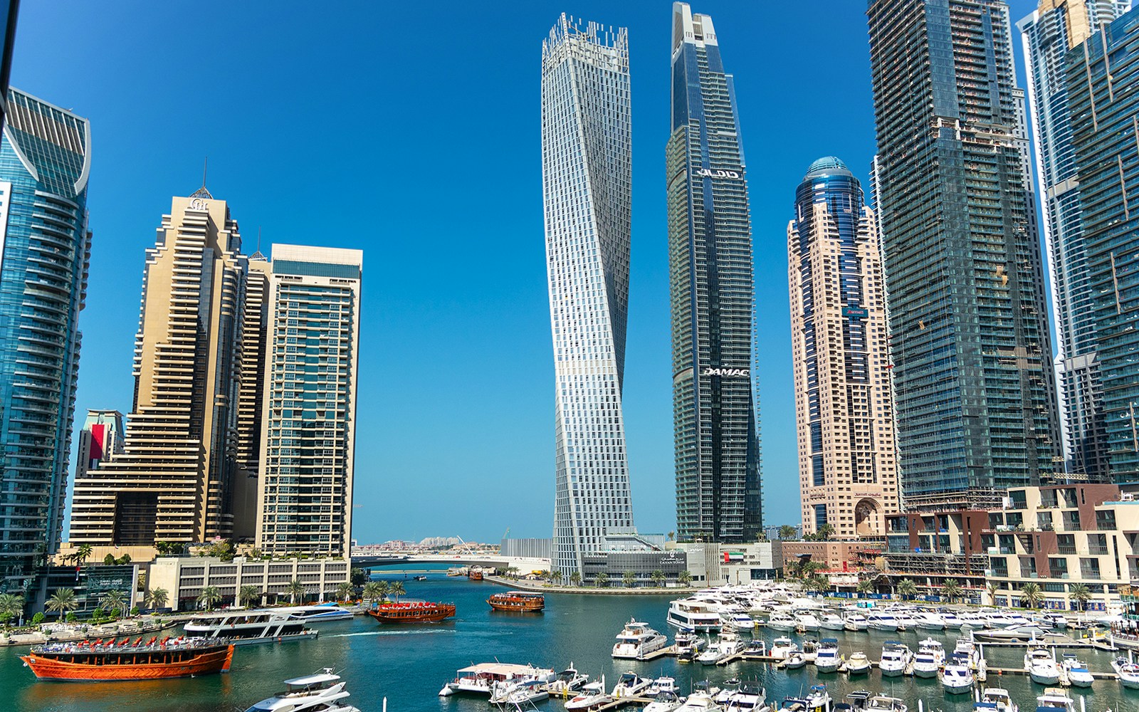 Cayan Tower Dubai spiraling skyscraper against a clear blue sky.