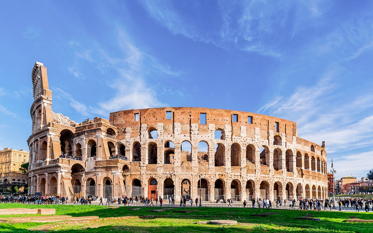 Colosseum exterior with tourists in Rome, Italy.