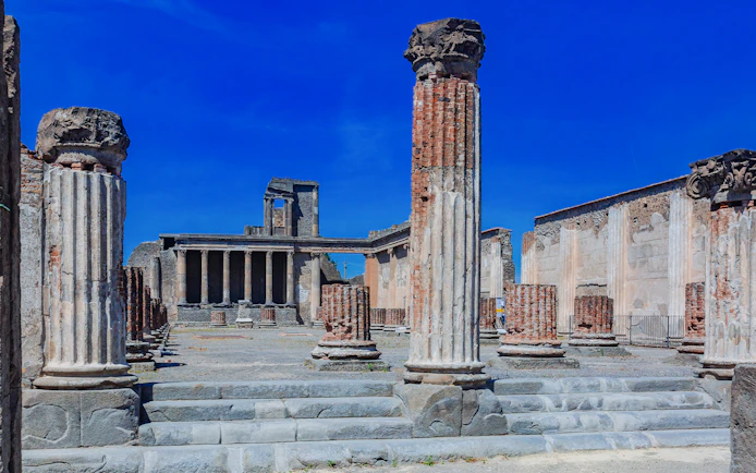 Ancient columns and ruins of The Basilica in Pompeii, Italy.
