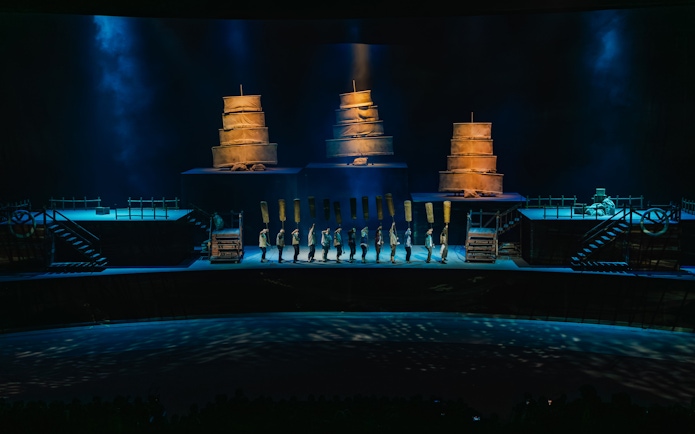 Performers on stage with ship sails at The Legacy of a Generation Show.
