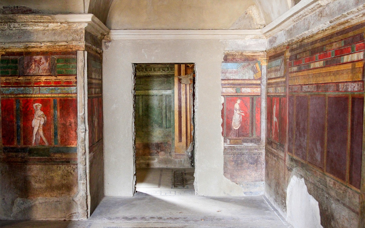 Frescoes in the Villa of the Mysteries, Pompeii, depicting ancient Roman figures.