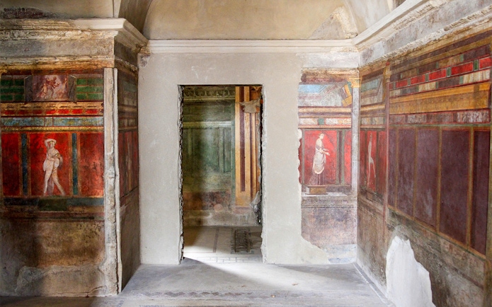 Frescoes in the Villa of the Mysteries, Pompeii, depicting ancient Roman figures.