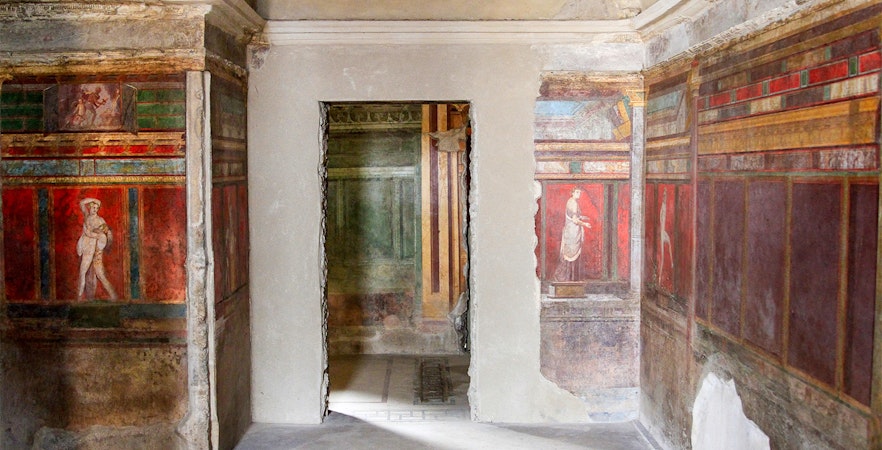 Frescoes in the Villa of the Mysteries, Pompeii, depicting ancient Roman figures.