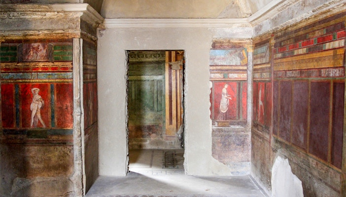 Frescoes in the Villa of the Mysteries, Pompeii, depicting ancient Roman figures.