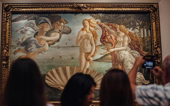 Tourists viewing "The Birth of Venus" by Botticelli at Uffizi Gallery, Florence.