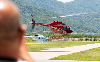 Helicopter taking off during Rio de Janeiro tour with mountains in the background.