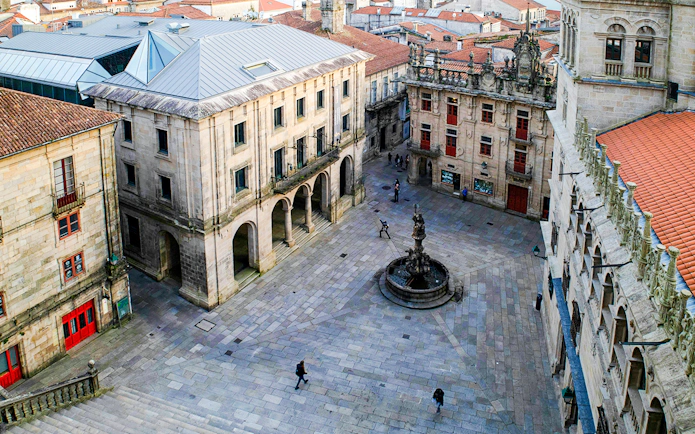 Plaza De Platerias in Santiago Compostela with fountain and historic buildings.