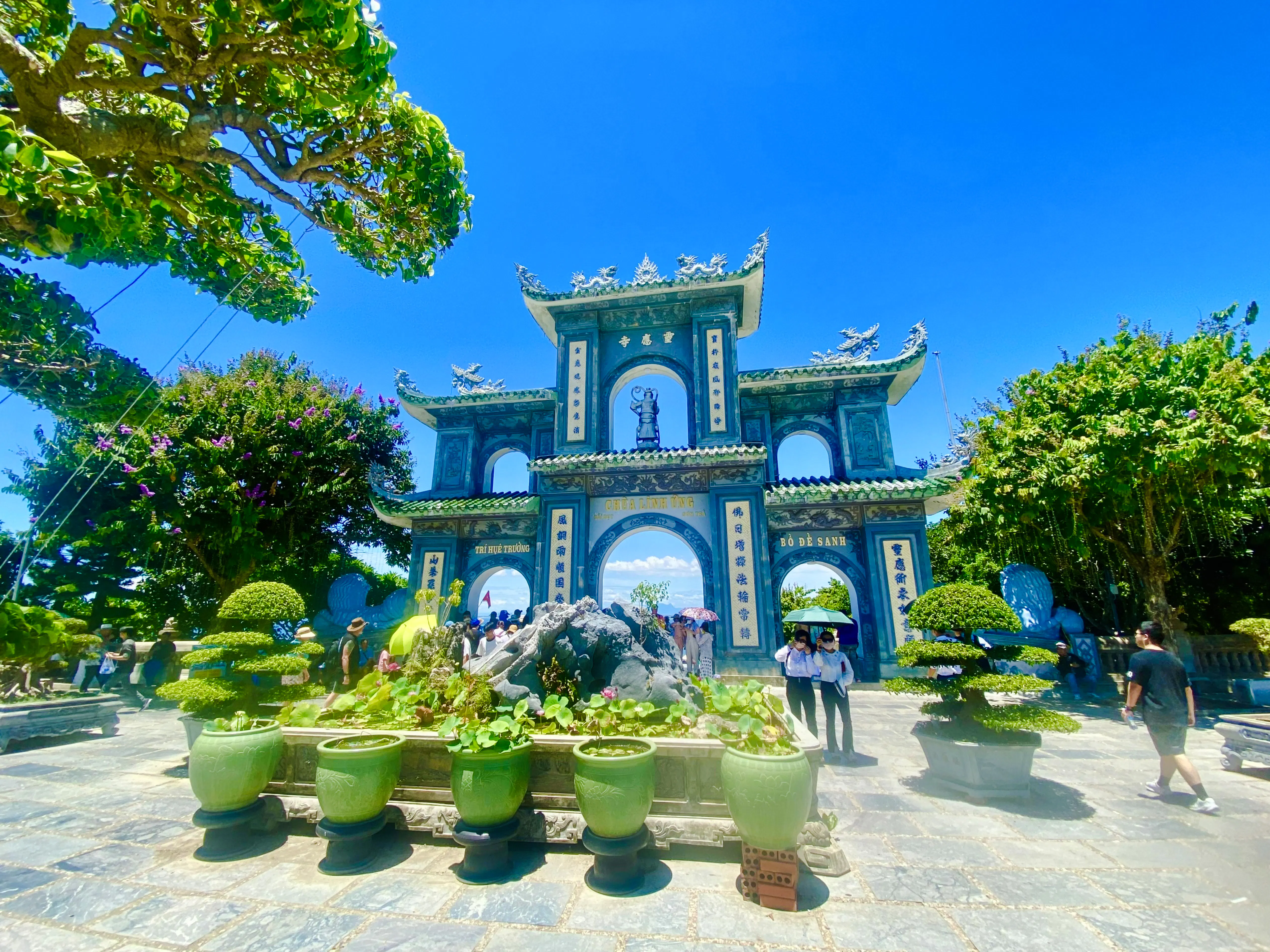 Marble Mountains entrance with tourists, Da Nang Coastal Charm Half-Day Cafe Tour.