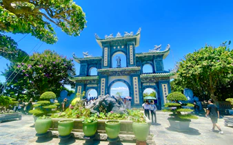 Marble Mountains entrance with tourists, Da Nang Coastal Charm Half-Day Cafe Tour.