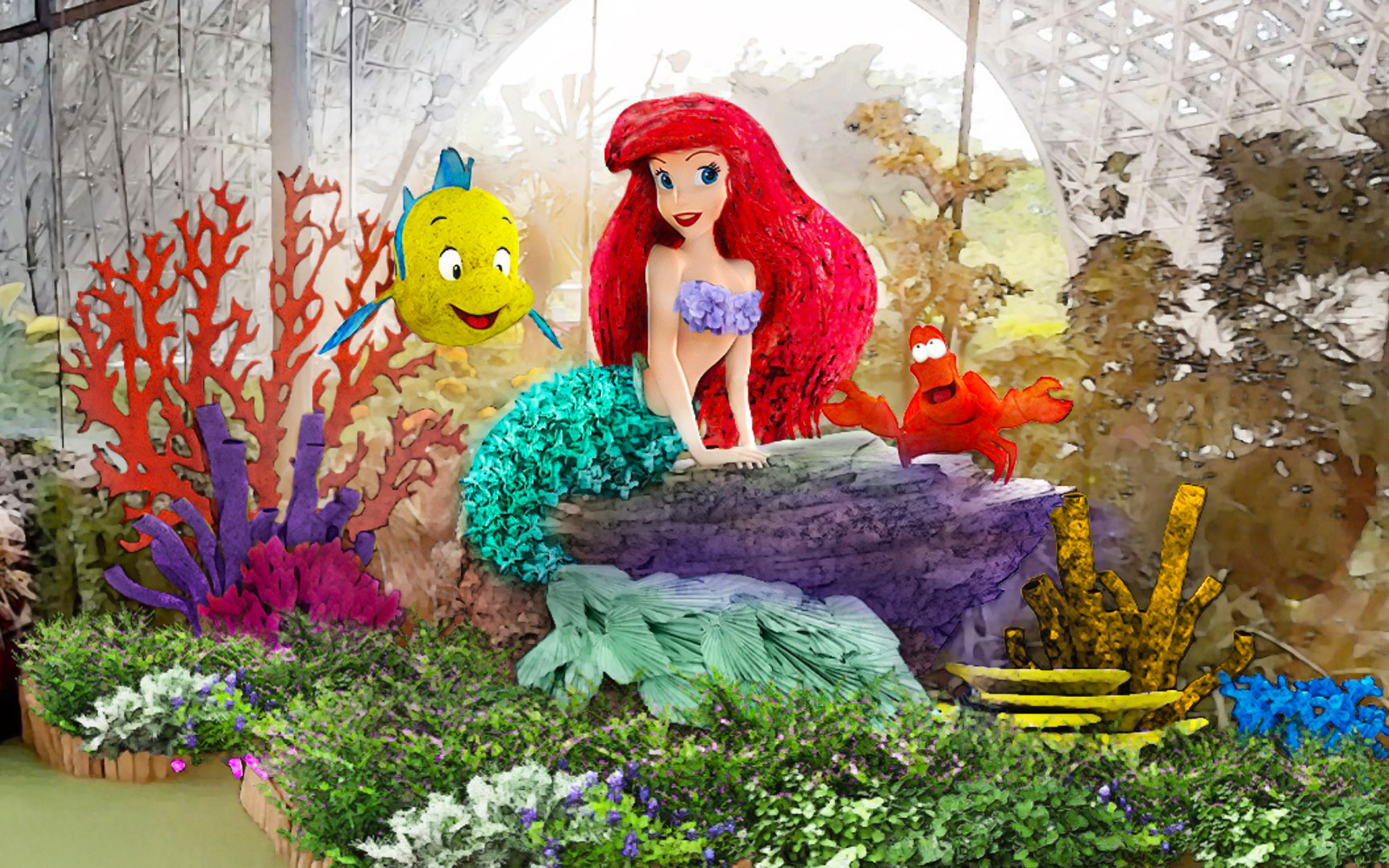 Colorful floral display with mermaid and sea creatures at Gardens by the Bay, Singapore.