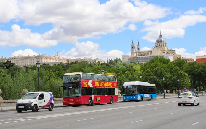 Panoramic view of Madrid with Big Bus HOHO tour passing Royal Palace and Almudena Cathedral.