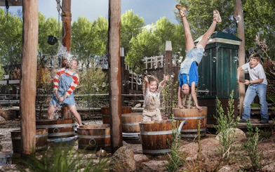 Children playing with water at Madurodam miniature park in the Netherlands.