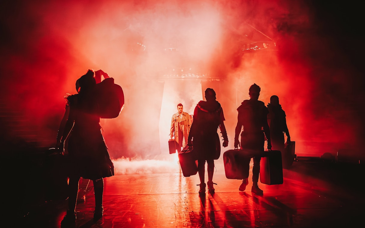 Performers on stage in dramatic lighting during Come Alive Westend show.