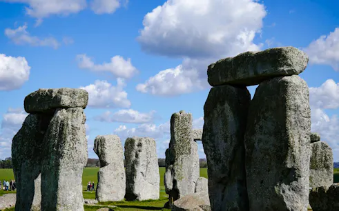 Stonehenge stone circle under blue sky on a half-day tour from London.