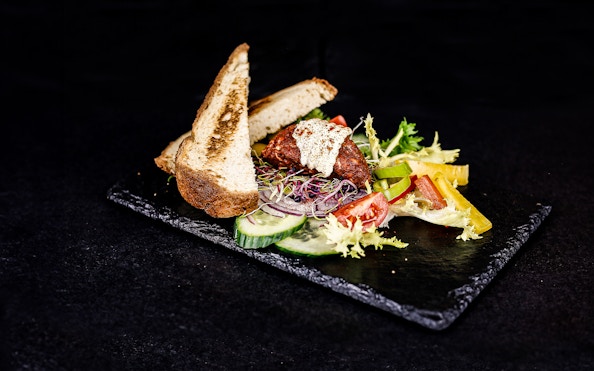 Traditional Hungarian dish with bread and vegetables on a Budapest dinner cruise.