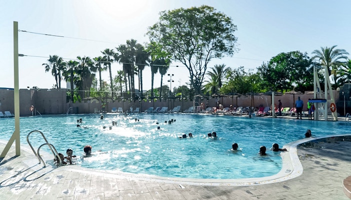 Reef pool at Isla Magica with visitors enjoying water activities in Seville, Spain.