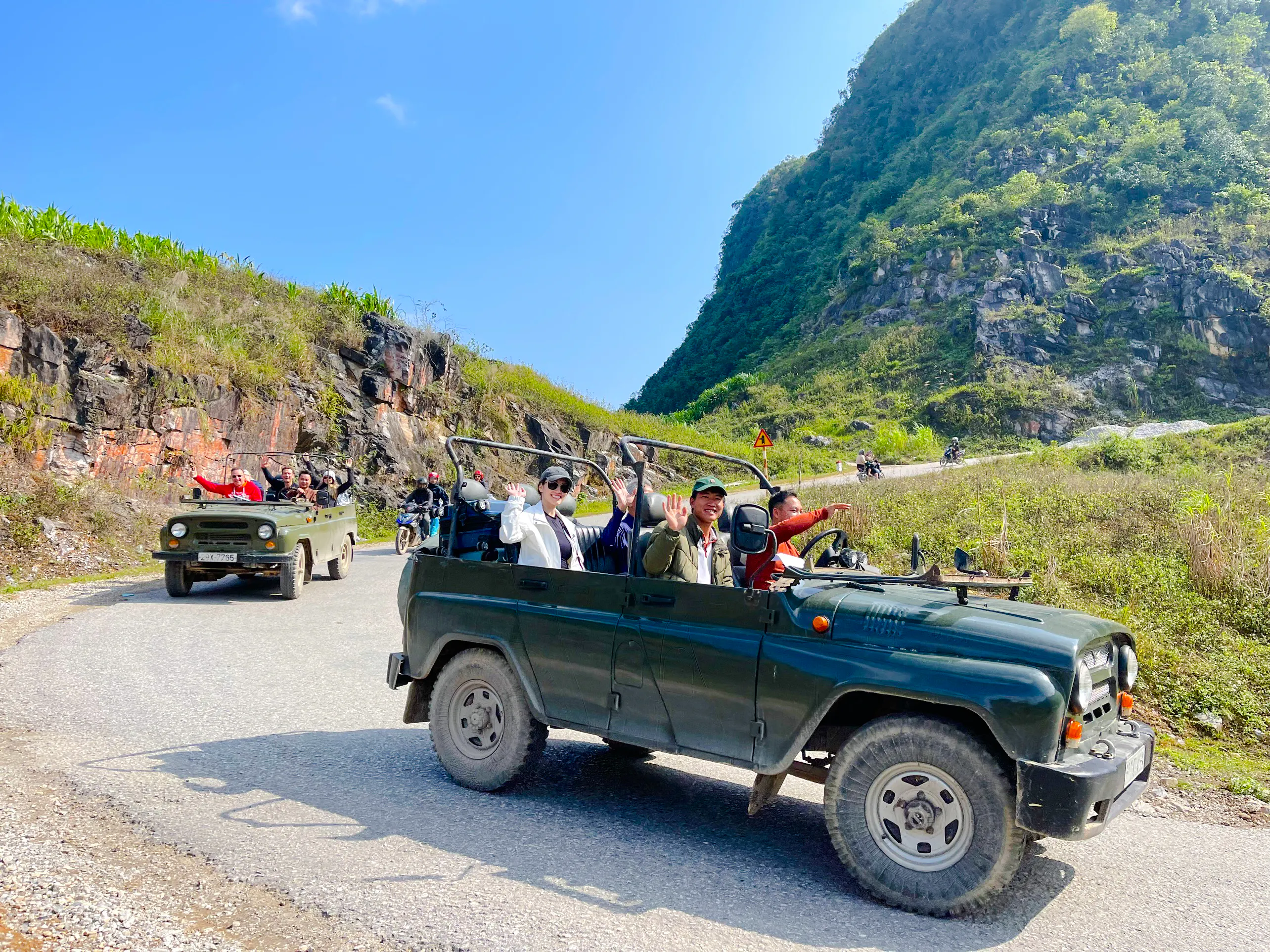 Tourists in a jeep on a scenic mountain road during the Sapa Jeep Half Day Tour, Sa Pa.