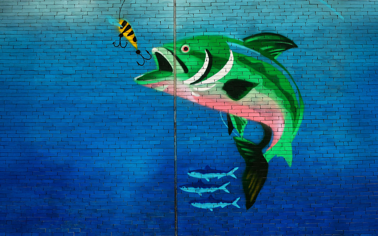 Mural of a large fish chasing a lure in Karama, Dubai.