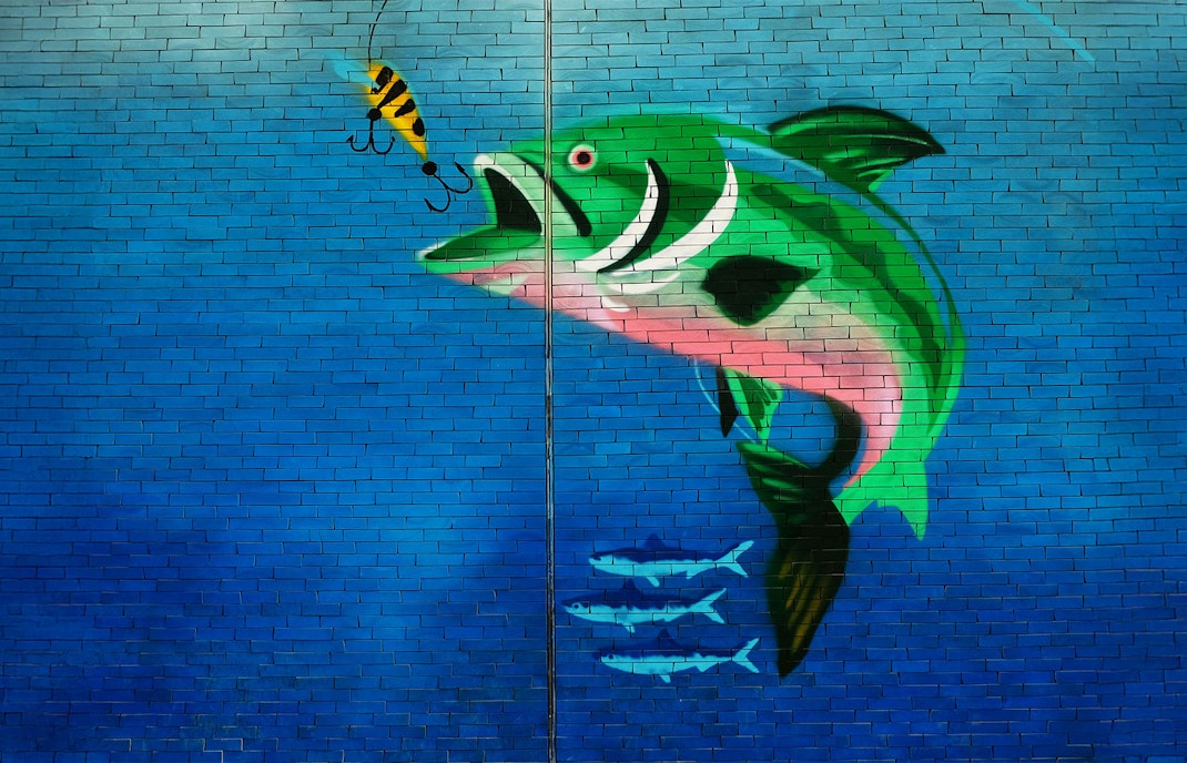 Mural of a large fish chasing a lure in Karama, Dubai.