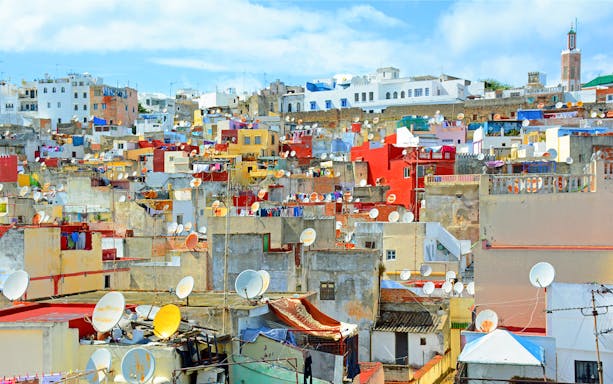 Colorful rooftops of Tangier, Morocco, with satellite dishes, seen on a day trip from Málaga.