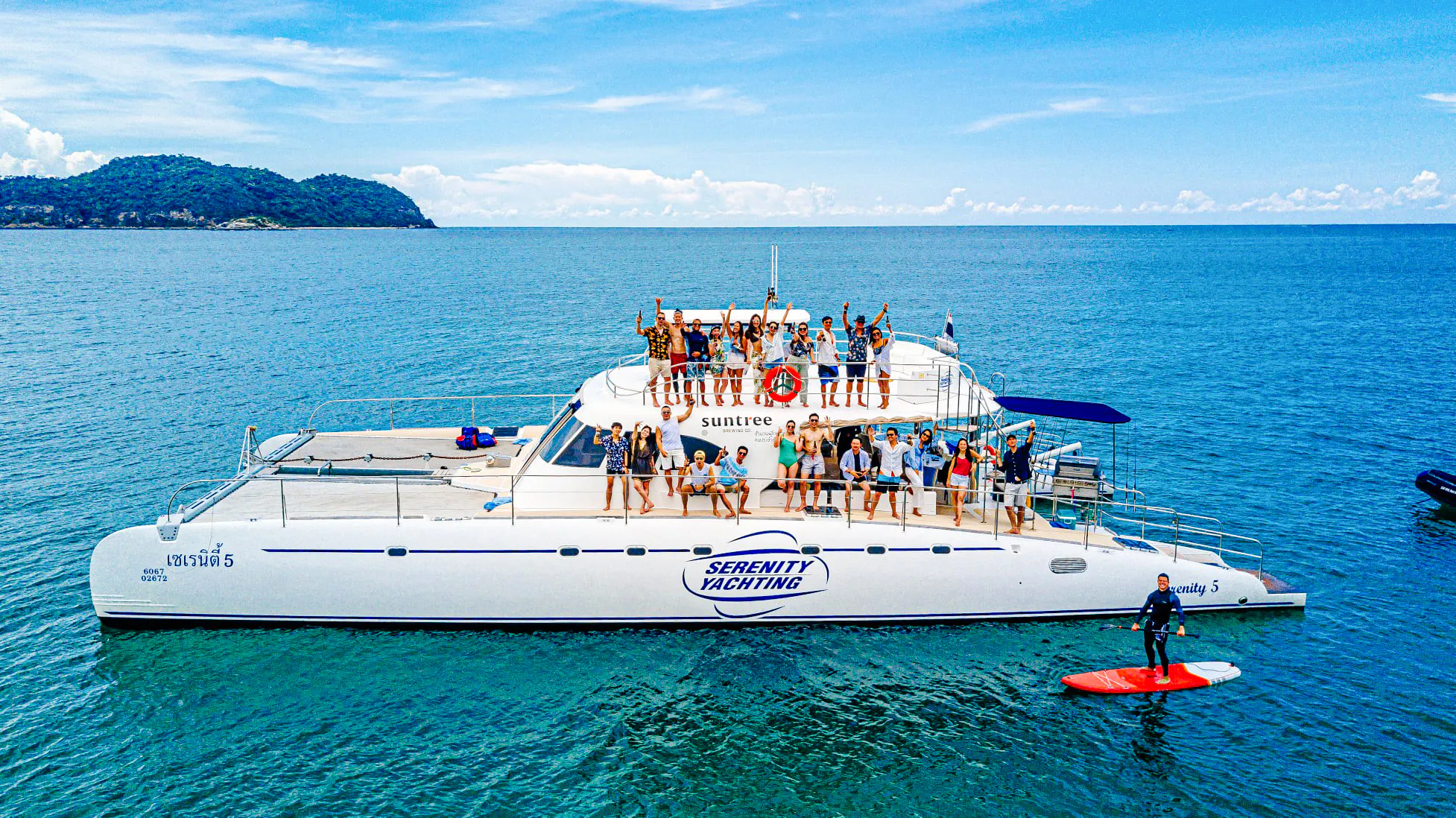 Group enjoying a sailing catamaran tour near Koh Phai, Pattaya.