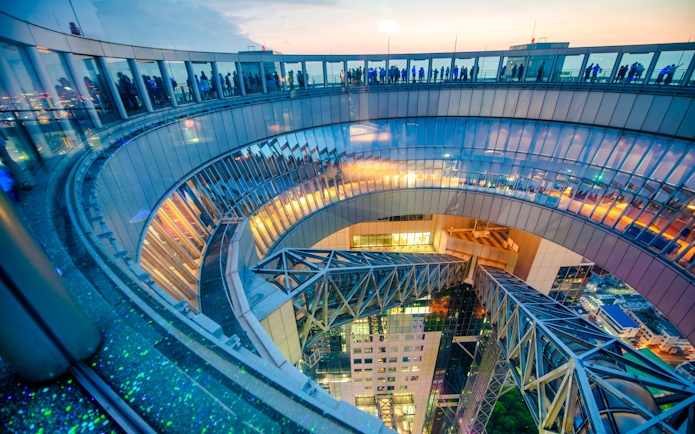 Umeda Sky Building observation deck at night with city lights, Osaka, Japan.
