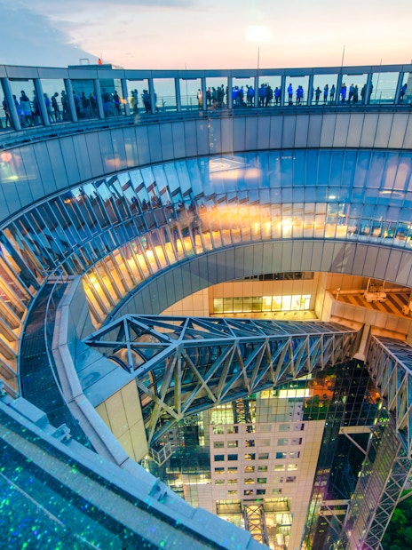 Umeda Sky Building observation deck at night with city lights, Osaka, Japan.