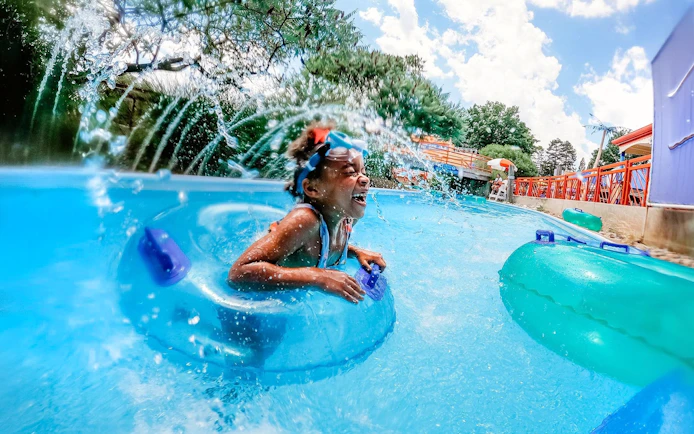 Child enjoying water ride at Sesame Place Philadelphia.
