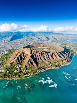Aerial view of Diamond Head crater and coastline in Honolulu, Hawaii.