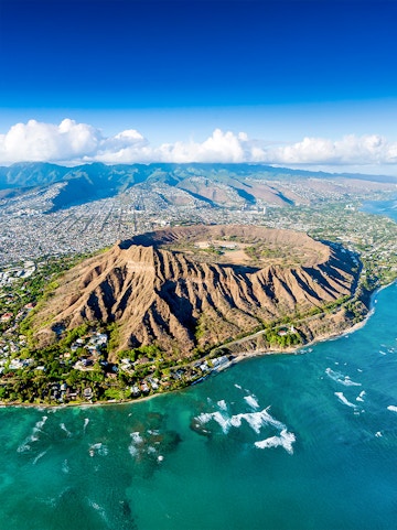 Aerial view of Diamond Head crater and coastline in Honolulu, Hawaii.