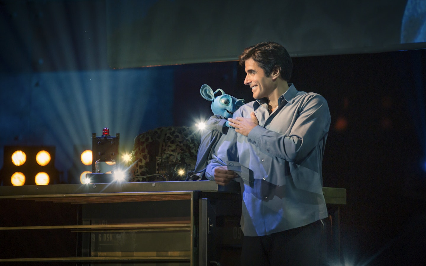 Magician performing with puppet during David Copperfield Vegas show.