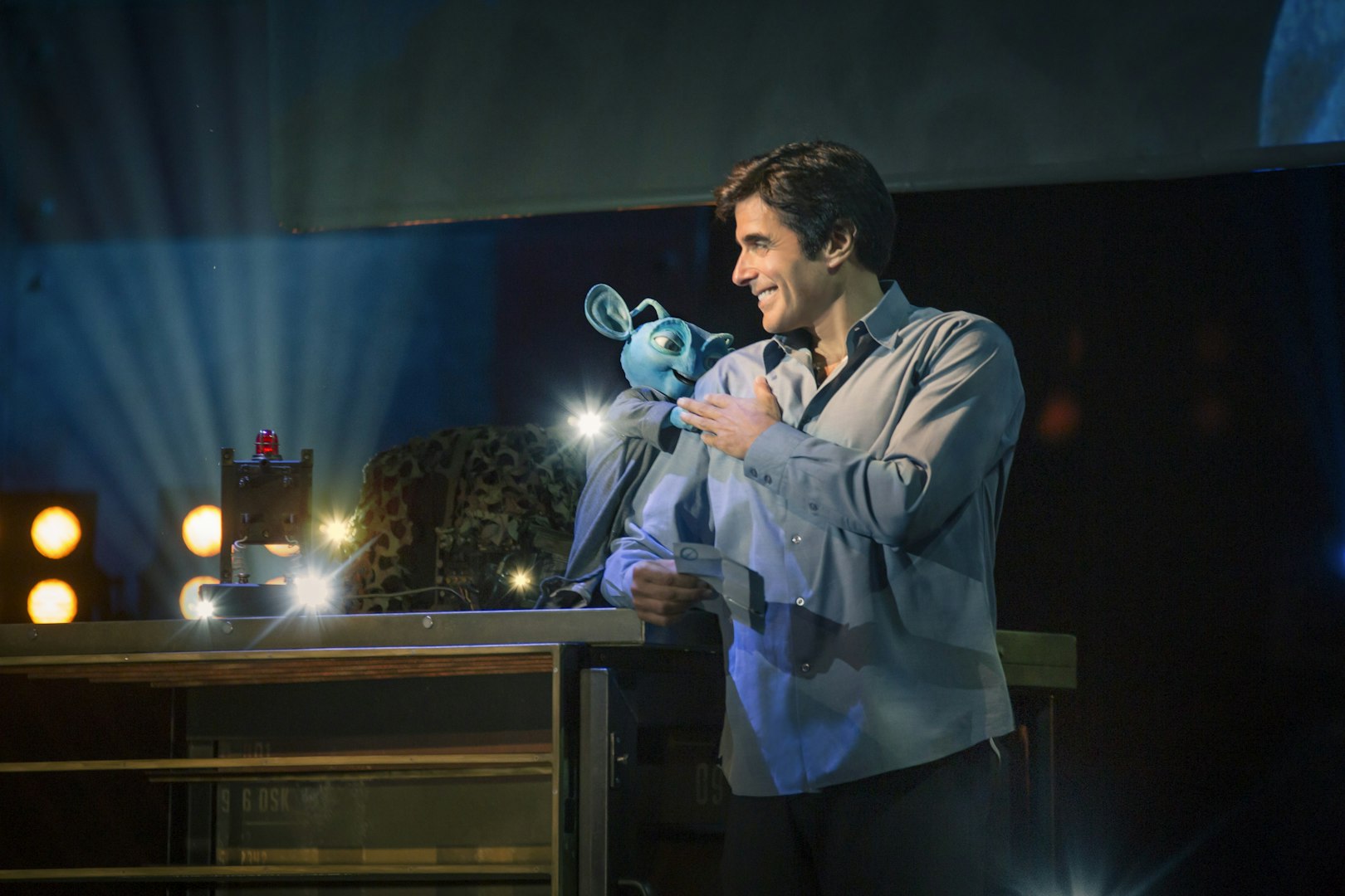 Magician performing with puppet during David Copperfield Vegas show.