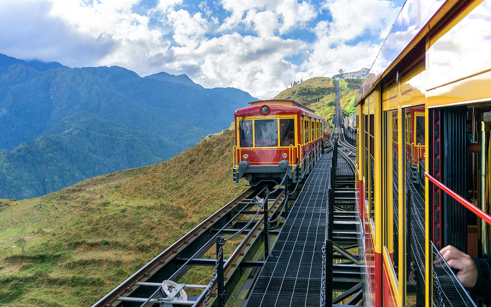 Red funicular train ascending Fansipan Mountain at Sun World Fansipan Legend, Vietnam.