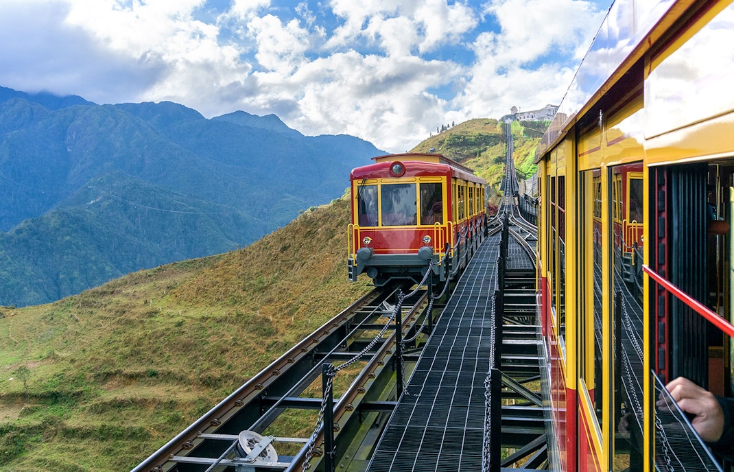Red funicular train ascending Fansipan Mountain at Sun World Fansipan Legend, Vietnam.