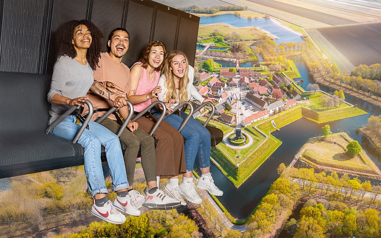 Guests enjoying the 5D Ultimate Flight Experience over a scenic landscape.
