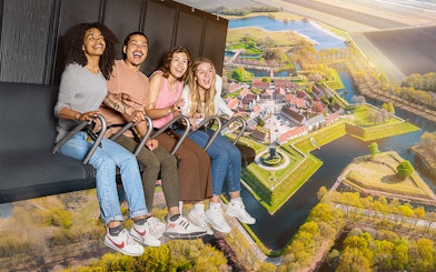 Guests enjoying the 5D Ultimate Flight Experience over a scenic landscape.