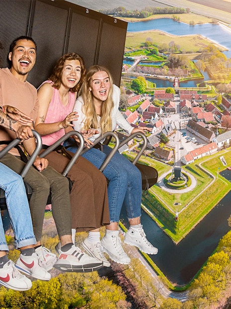 Guests enjoying the 5D Ultimate Flight Experience over a scenic landscape.