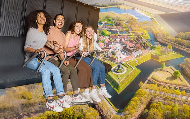 Guests enjoying the 5D Ultimate Flight Experience over a scenic landscape.