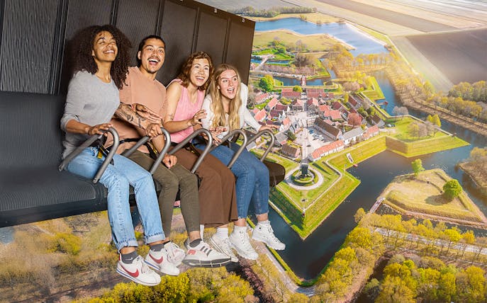 Guests enjoying the 5D Ultimate Flight Experience over a scenic landscape.