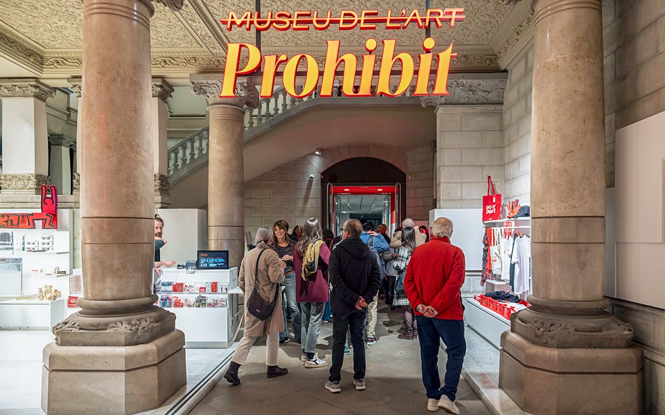 Visitors entering the Museum of Forbidden Art with gift shop in view.