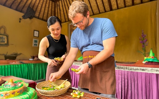 Participants preparing traditional dishes at Jambangan Bali Cooking Class in Ubud.