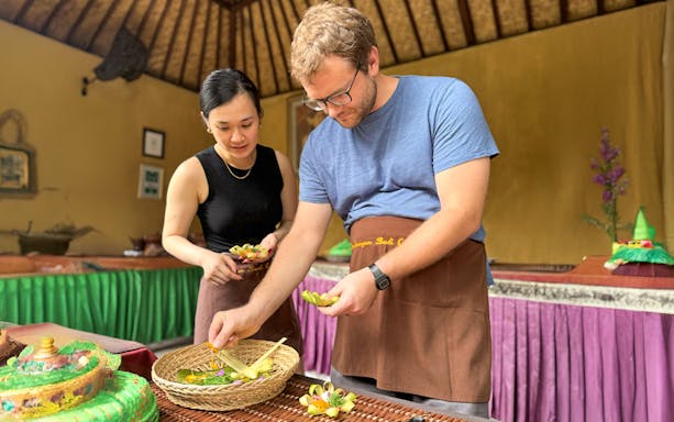 Participants preparing traditional dishes at Jambangan Bali Cooking Class in Ubud.