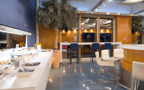 Skyserv Melina Merkouri Lounge seating and buffet at Athens International Airport Hall B.
