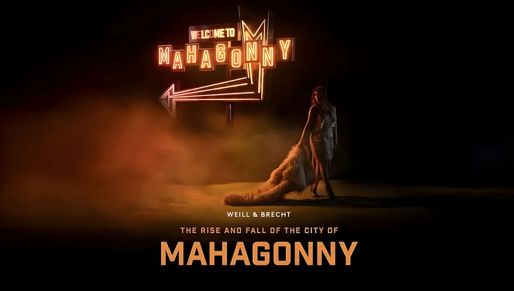 Neon sign reading 'Welcome to Mahagonny' with a person standing beside it, related to the Rise and Fall of The City of Mahagonny.