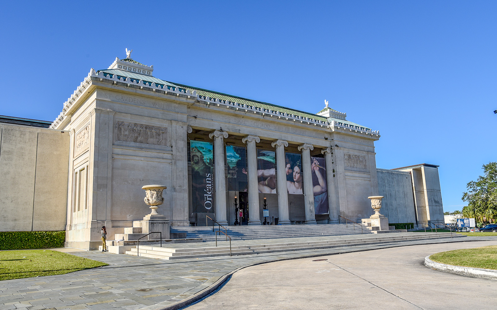 New Orleans Museum of Art exterior with visitors exploring the sculpture garden.