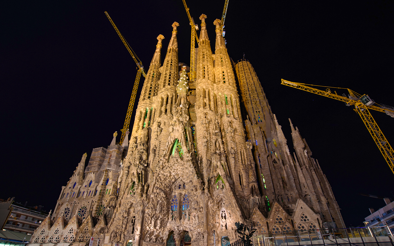 Night view of the illuminated Nativity Façade of Sagrada Familia in Barcelona.