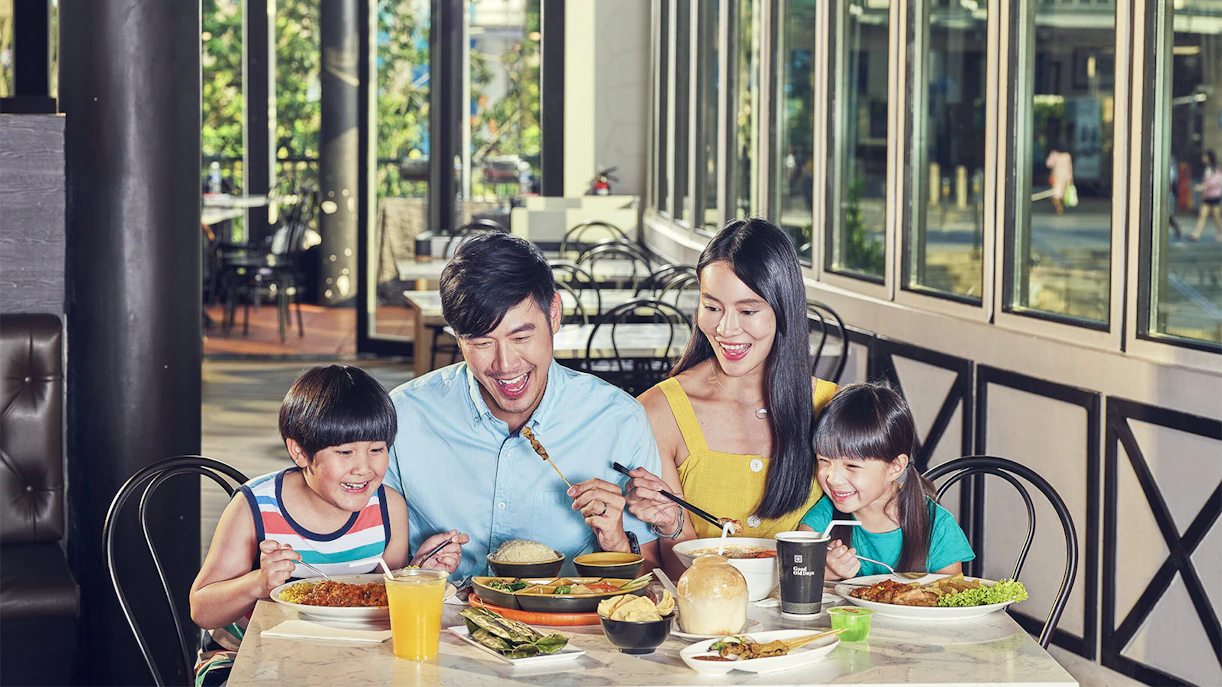 Family enjoying lunch at Arbora restaurant with various dishes on the table.