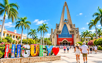 Higüey Basilica with colorful letters and tourists in Punta Cana.