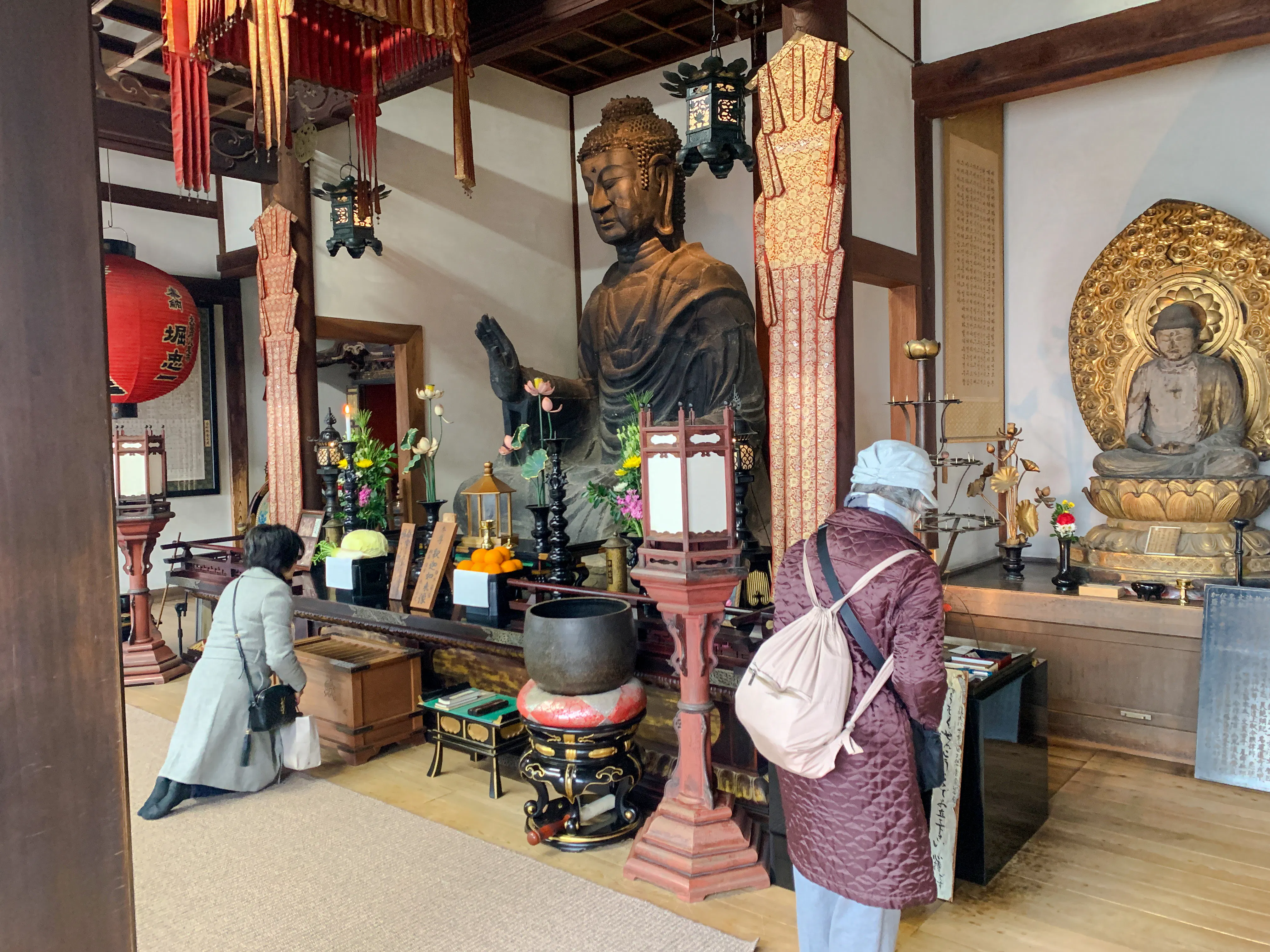 Buddha statues inside a temple in Nara, Japan, visited during the Asuka Nara Historical E-bike tour.