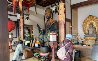 Buddha statues inside a temple in Nara, Japan, visited during the Asuka Nara Historical E-bike tour.